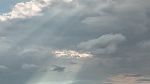billowing clouds and sunrays