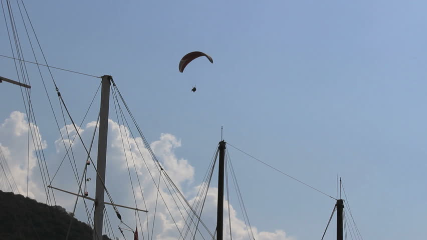 Parasail from the mountains with masts of sailing boats