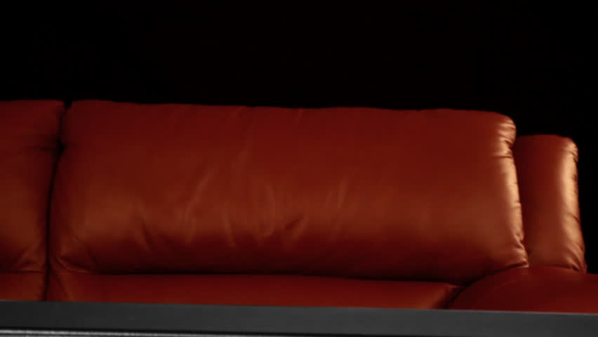 man jumping over couch