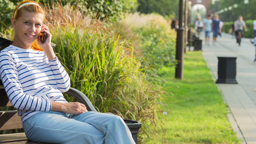 Woman Talking on the Phone in Park