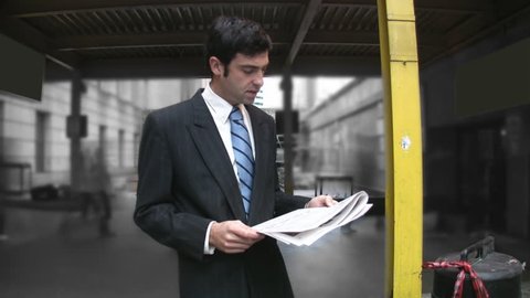Man reads newspaper. Timelapse commuters in background. Stock Video