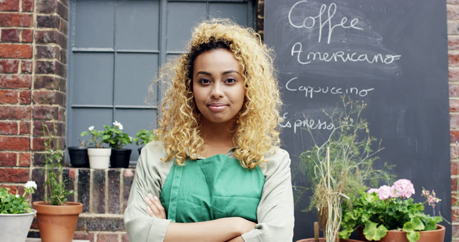 Mixed race barista pretty woman portrait outside cafe