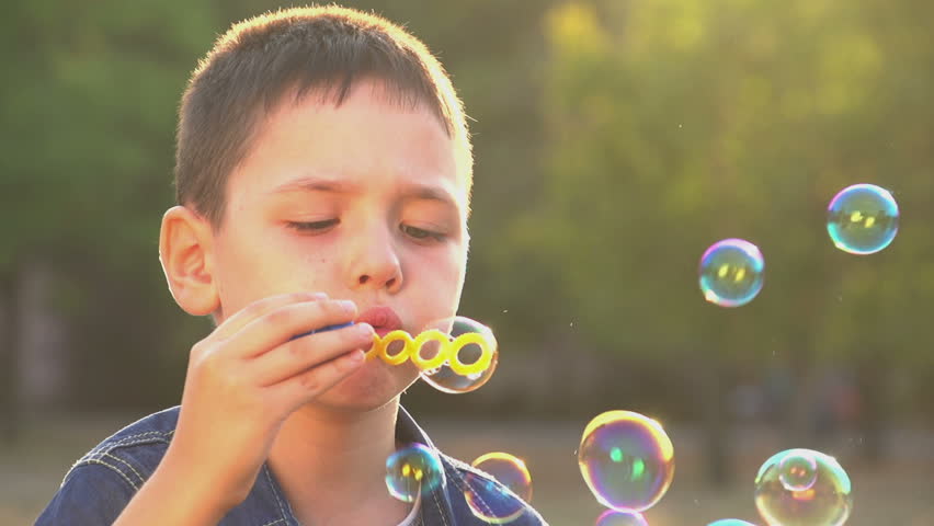 blowing soap bubbles