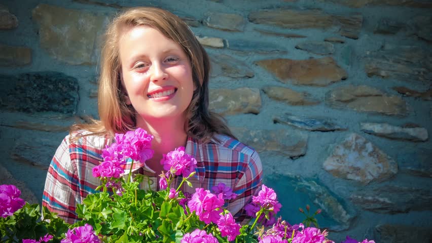 beautiful girl and geranium flowers