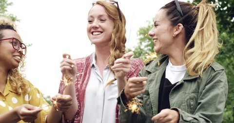 Girl friends holding sparklers celebrating 4th july independence day new years Stock Video