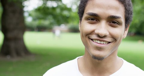Close up portrait happy young mixed race man smiling at camera