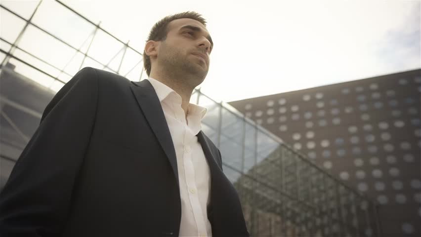 Business, technology and business people concept - businessman with smartphone over office building waiting for someone | Shutterstock HD Video #7372513