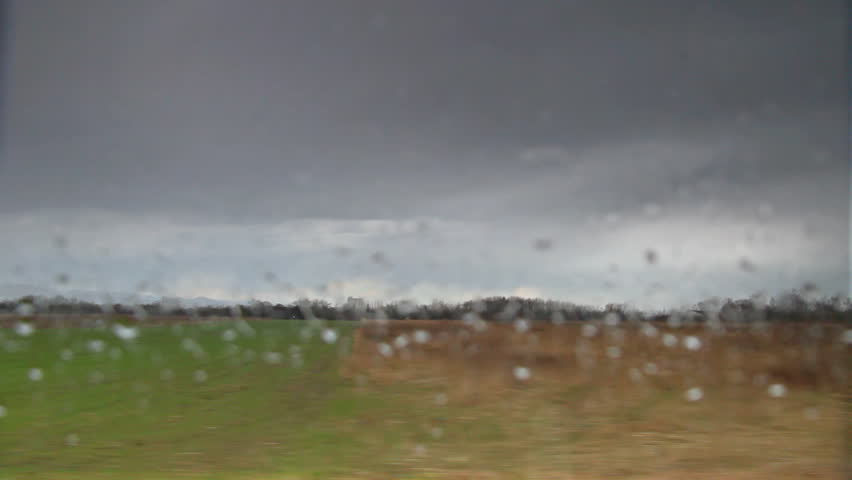 Driving car through country rain