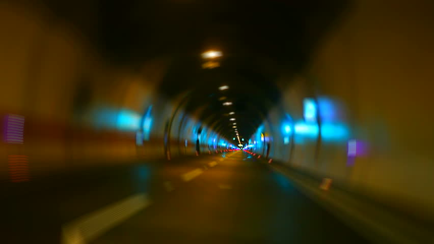 Car driving on highway tunnel looping high speed zoom
