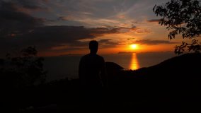 Man with Hands up at Sunset at the Top of the Mountain. Uplifting and Motivational Video. Koh Samui. Thailand. Slow Motion.
