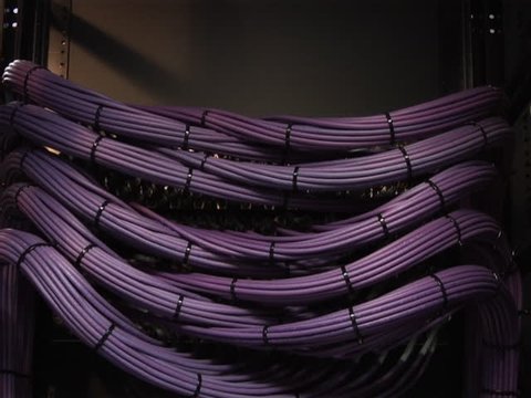 This high definition footage is of a video server cables. The camera pans slowly down to reveal a organized video cable structure in PAL format. Other formats available