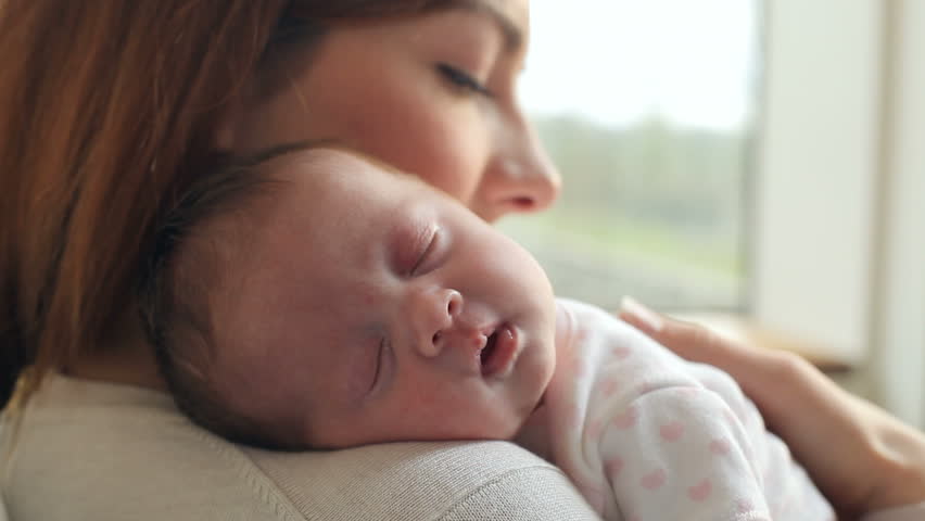Mother At Home With Sleeping Newborn Baby Daughter Royalty-Free Stock Footage #7388047