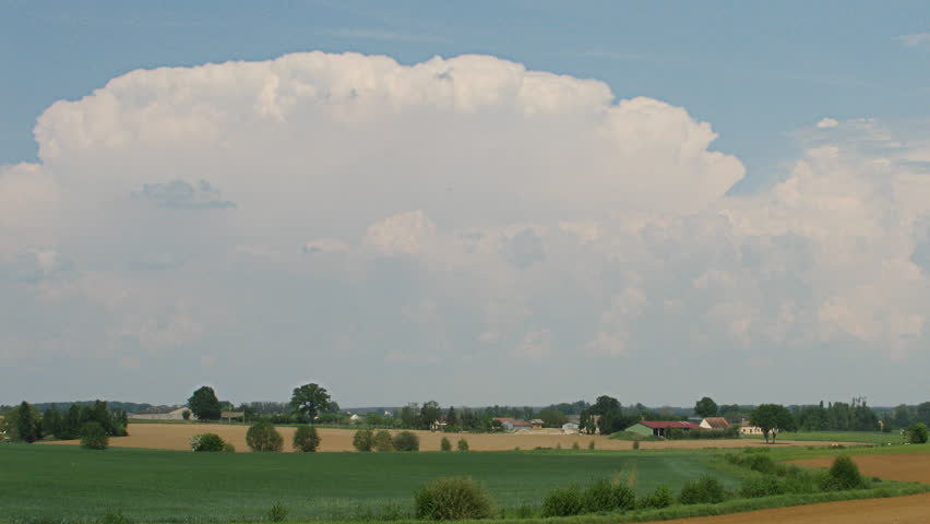 Storm in formation over farm & fields, HD time lapse clip
