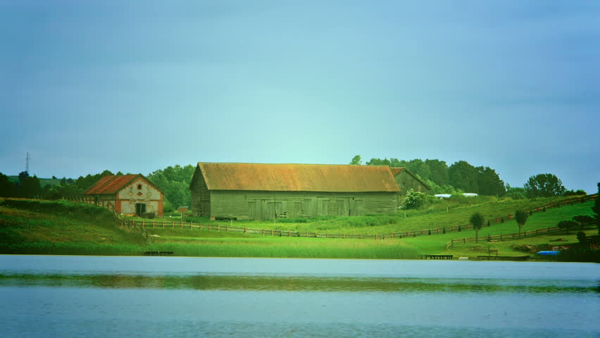 Large barn on the lake.
Video footage of large barn on the lake on a sunny day.