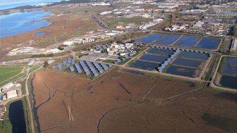 Aerial view over solar energy plant & industrial land 