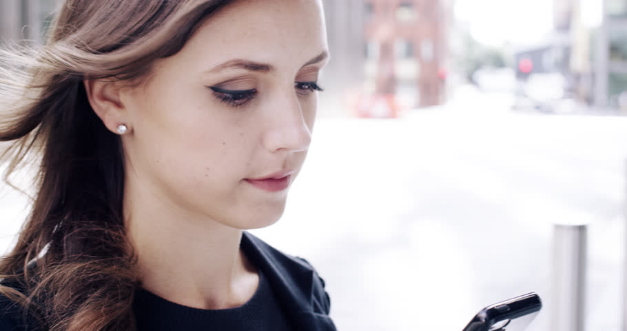 Attractive business woman commuter using smartphone in city of london - RED EPIC DRAGON 6K