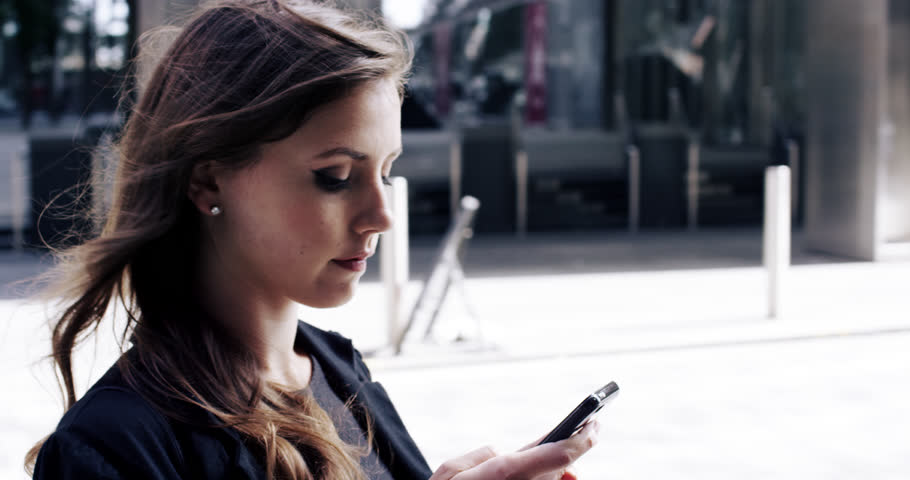 Attractive business woman commuter using smartphone in city of london - RED EPIC DRAGON 6K