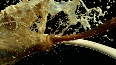 Coffee and milk collision splash in midair shot with high speed camera, phantom flex.