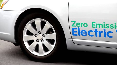 Close up of an electric vehicle driving off.
