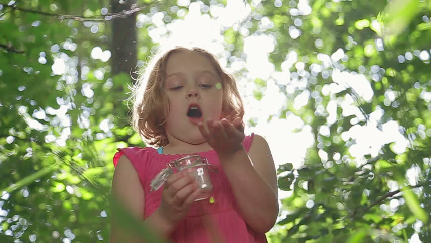 Closeup Of Little Girl Making A Wish, From Her Jar Full Of Dandelion Seeds | Shutterstock HD Video #7409641