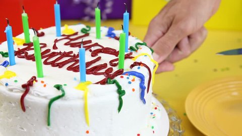 Cutting a slice of birthday cake.