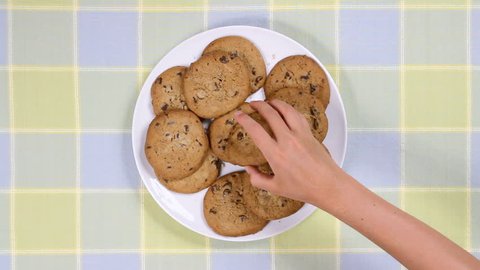 Plate full of cookies being snatched up by four children. Clip is 2x normal frame rate.