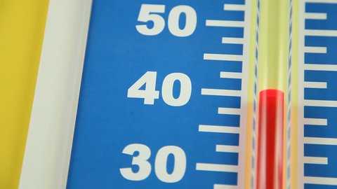 Close up of a Celsius thermometer showing a rapid rise in temperature in the range of 30 to 50 degrees.