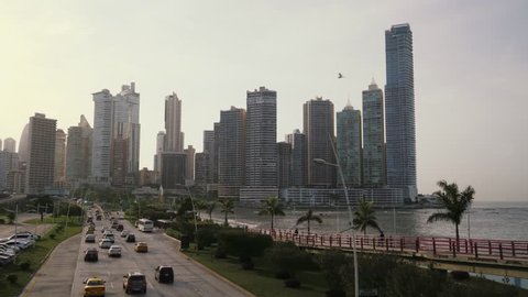 Urban scene. Timelapse of cars and buses in Panama City. People and commuters driving along Avenida Balboa and Cinta Costera. Landscape in Central America, Latin America, South America. 2of19