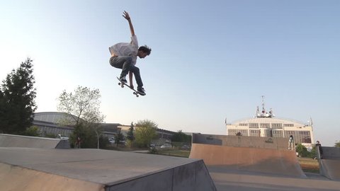 Slow Motion Shot Of A Skilled Skateboarder Mastering Performing An Ollie In Skateboard Park