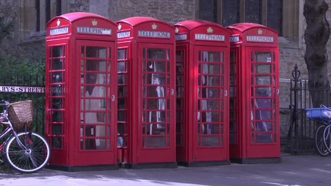 CAMBRIDGE, UK, SEPT 2014. A row of 4 iconic Giles Gilbert Scott design red British model K6 telephone boxes near the market square in Cambridge.