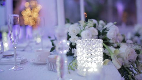 Decorative table setting with empty wine glasses at a wedding reception. Soft focus 1080p HD.