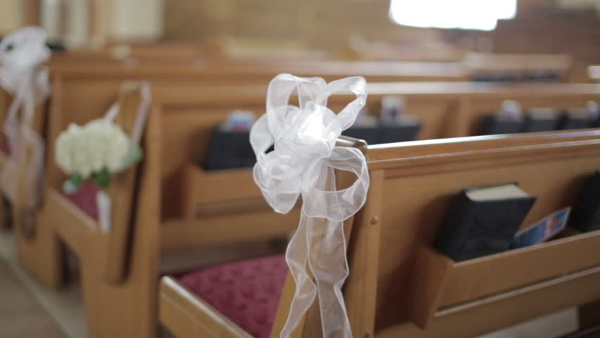 Decorated pews inside a generic church. 1080p HD.