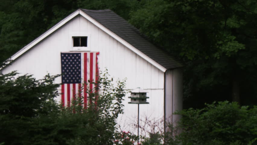 American flag on generic white barn. Shot on RED SCARLET, 1080p HD.