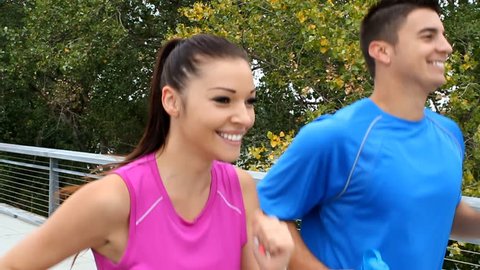 Close up of young man and woman staying fit by running/jogging. Slow motion conformed from 60fps.