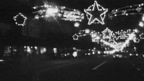 HOLLYWOOD CALIFORNIA - December 2:  Vintage super 8 night time lapse footage of Christmas holiday lights and traffic along Hollywood Blvd in Los Angeles, California.