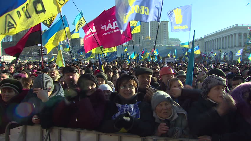 KIEV, UKRAINE - FEBRUARY 9, 2013:People at the rally, shouting and waving flags.  People