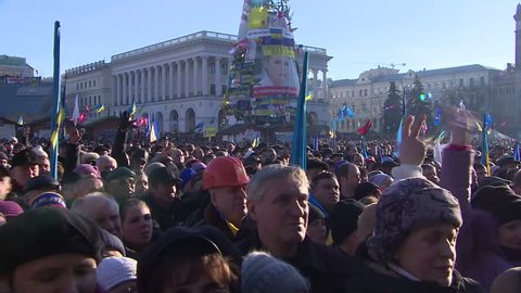 KIEV, UKRAINE - FEBRUARY 9, 2013:People at the rally, shouting and waving flags.  People's Veche on Maidan Nezalezhnosti (Independence Square).