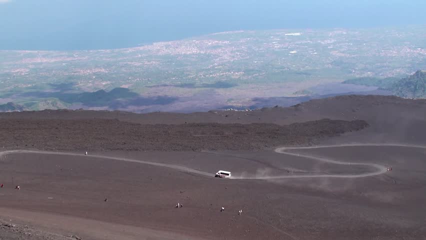 Terrain vehicles & Tourists on the long way to the crater area of Mount Etna. Sicily, Italy.