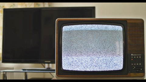 Analog TV sat next to modern day LED television. 76 years of television history came to an end at midnight on Wednesday 24 October 2012 when the analogue TV signal was switched off. (UK, July 2014) 