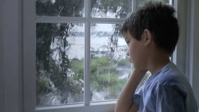 Full HD Child looking through rainy window, multiple angle sequence stock video footage clip