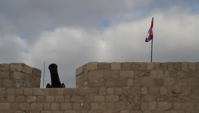 Cannon and flag on old city castle wall of Dubrovnik in Croatia