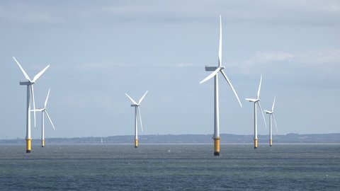 Tracking shot of wind turbines in Liverpool Bay in the Irish Sea, England, UK