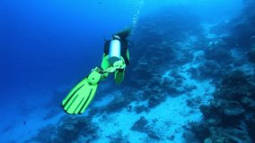 Female scuba diver swimming underwater 