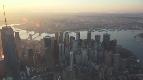 New York City sunrise and early morning light Financial District aerial. Crossing to East River B Bridge. 4K, dedicated plane, hard mounted open window allows a saturated, clear edge on the shot.