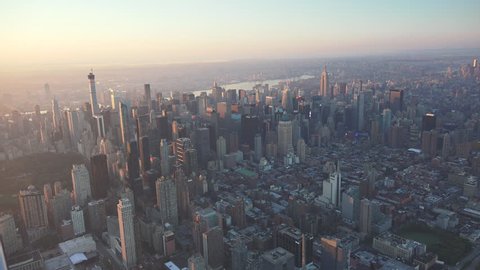 New York City midtown from Central Park South-East aerial sunrise and early morning light. Shot in 4K, dedicated plane, hard mounted open window allows a saturated, clear edge on the shot.