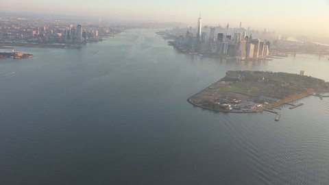 Governors Island looking N to New York City aerial sunrise and early morning light. Shot in 4K, dedicated plane, hard mounted open window allows a saturated, clear edge on the shot.