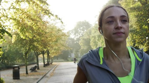 Runner woman running in park exercising outdoors fitness tracker wearable technology 库存视频