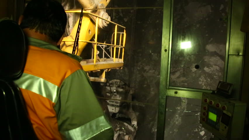 The excavator loads dump truck. Night mode.