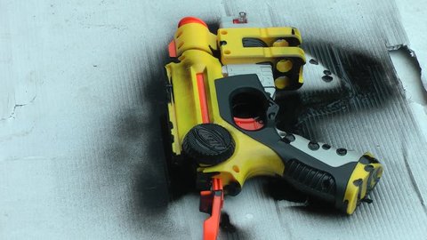 Toy gun being sprayed black