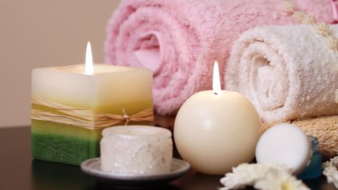 Spa accessories (moisturizer, candles, towels) at therapy center 